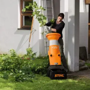 a woman using a STIHL GHE 150 Electric Shredder