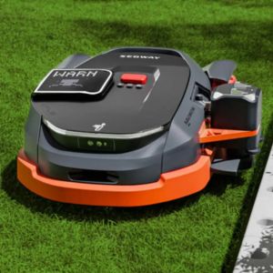 the Segway Navimow X390E Robotic Mower mowing the edge of a lawn