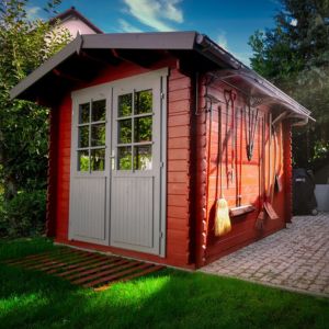 a double door garden shed with long handled tools hanging off its side