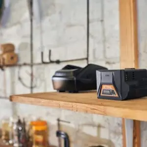 2 power tool batteries on a wooden shelf