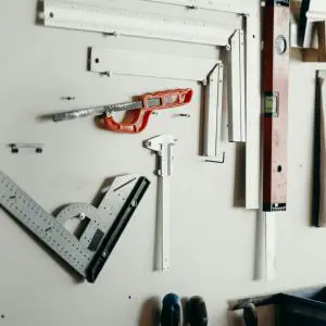 a variety of tools hanging on a white wall