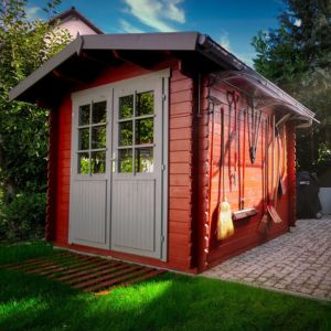 a garden shed with glazed double doors and tools hanging on the outside wall