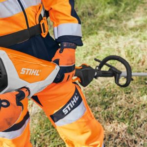 a man dressed in orange garden PPE, checking his garden tool