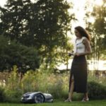 a woman operating a robotic mower using her phone