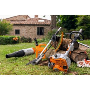 a STIHL KM 56 RC-E Petrol KombiEngine and Kombi tools, positioned next to log on a lawn