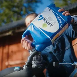Lawnmower being topped up with aspen fuel
