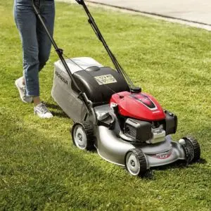 a close up of a HONDA IZY HRG 466 SK Petrol Self-Propelled Lawnmower in action