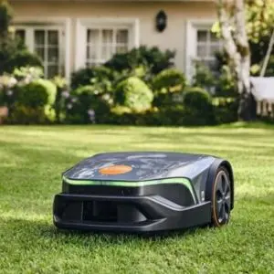 a grey STIHL robot mower on a lawn, with a house in the background