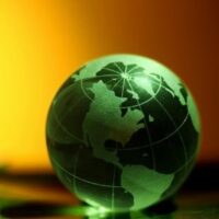 a green model of the world against a golden backdrop