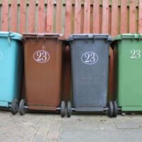 blue, brown, grey and green recycling bins