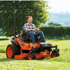 a man cutting grass in a field using the Kubota ZD1211 Zero Turn Mower