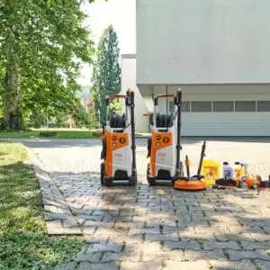 2 STIHL RE 150 PLUS Electric Pressure Washers and various cleaning solutions outside a large, white building