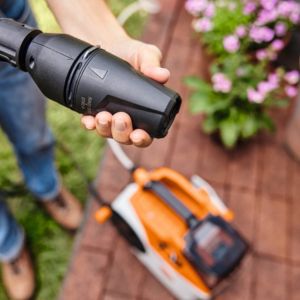 someone adjusting a pressure washer nozzle