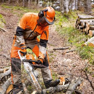 a man dressed in orange chainsaw PPE, using a chainsaw to cut a tree branch