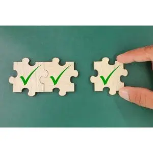 someone moving one of three jigsaw pieces, each of which displays green ticks