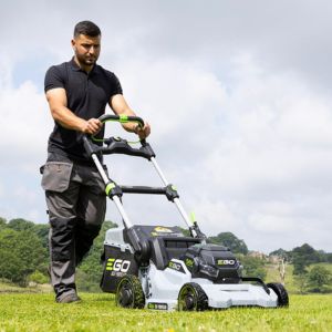 a man mowing grass using an EGO cordless lawnmower