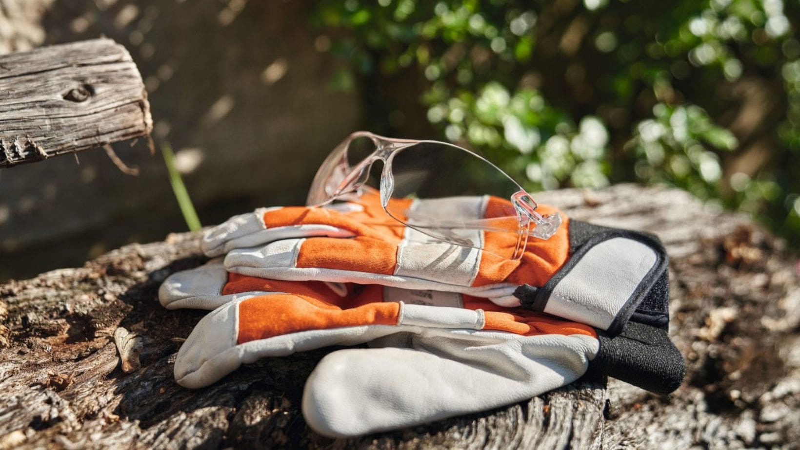 STIHL Function Safety Glasses and gloves on top of a log