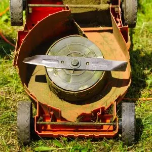the underside of an orange lawnmower