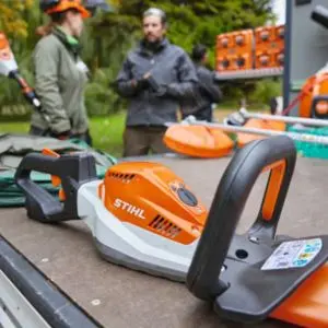 a man and woman on an outdoor worksite, surrounded by STIHL tools