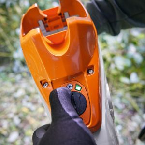 a close up of someone fitting Smart Connector 2A to a STIHL cordless tool