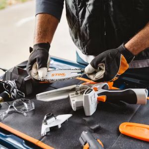 a man changing the guide bar on a STIHL GTA 26