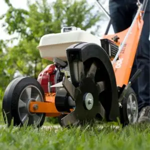 a close up of the Eliet KS 300 PRO Petrol Edge Cutter on a lawn