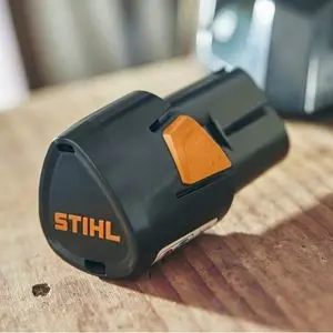 a close up of a STIHL AS 2 Battery on a wooden worktop