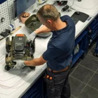 an overhead shot of a Husqvarna technician servicing an Automower
