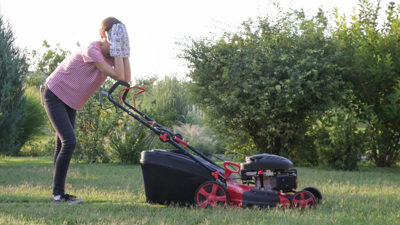 lawnmower cutting out (1) a woman with her head in her hands, while resting her elbows on a lawnmower handle