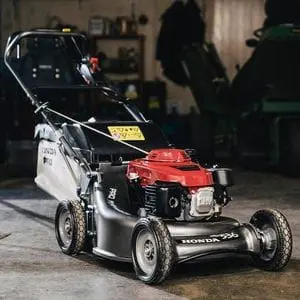 the Honda HRH 536 HX Petrol Lawn Mower parked in a garage