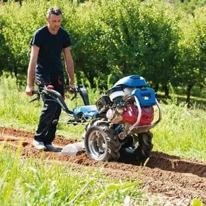 a man cultivating soil using the BCS 738 PowerSafe® 2-Wheel Tractor