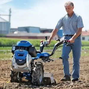 a man cultivating soil using the BCS 740 PowerSafe® 2 Two Wheel Tractor