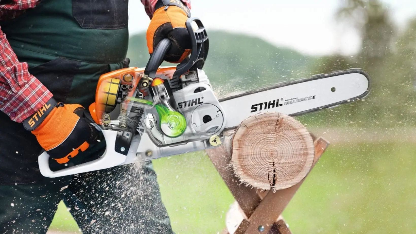someone cutting a log on a sawhorse, using the STIHL MS 231 Petrol Chainsaw