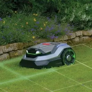 an EGO AURA-R2 Robotic Lawn Mower on a lawn, next to a garden bed, with a grid overlay demonstrating its wireless capabilities